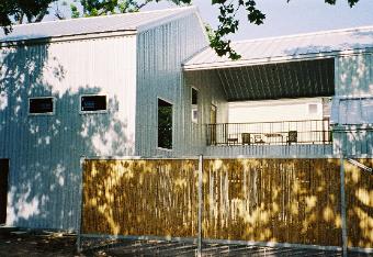 Modern Custom Home with Bamboo Fencing & Barn like Structure