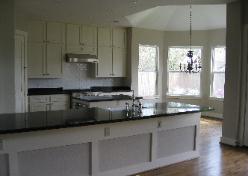 Open Kitchen White with Black Countertops
