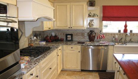 Close up of Kitchen Renovation with Custom Vent Hood, Stainless Steel Appliances and Granite Counters